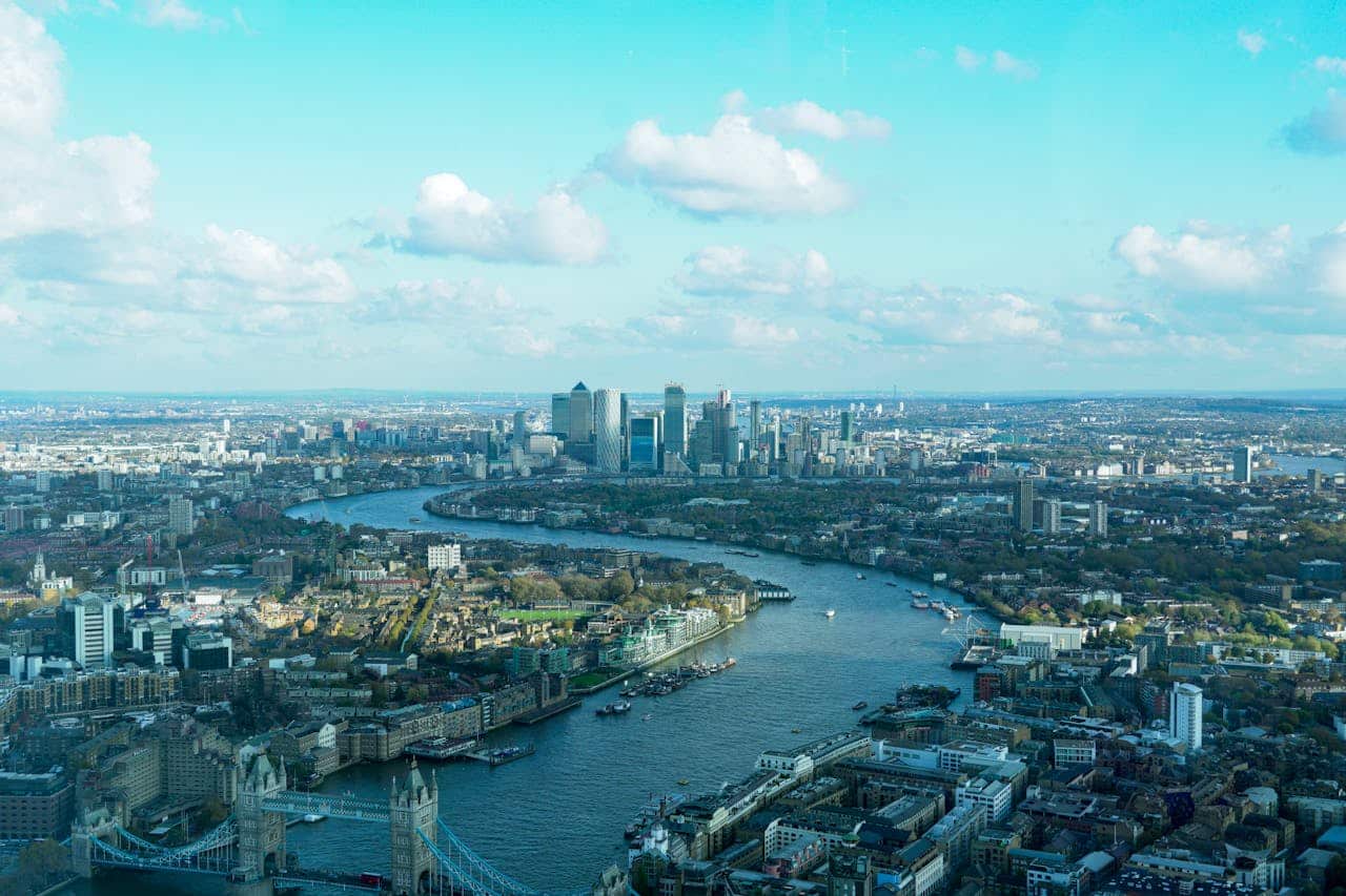 An aerial photo of the River Thames with the City in the background